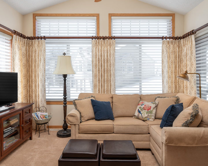 Floor to ceiling windows with layered drapery panels St Paul MN