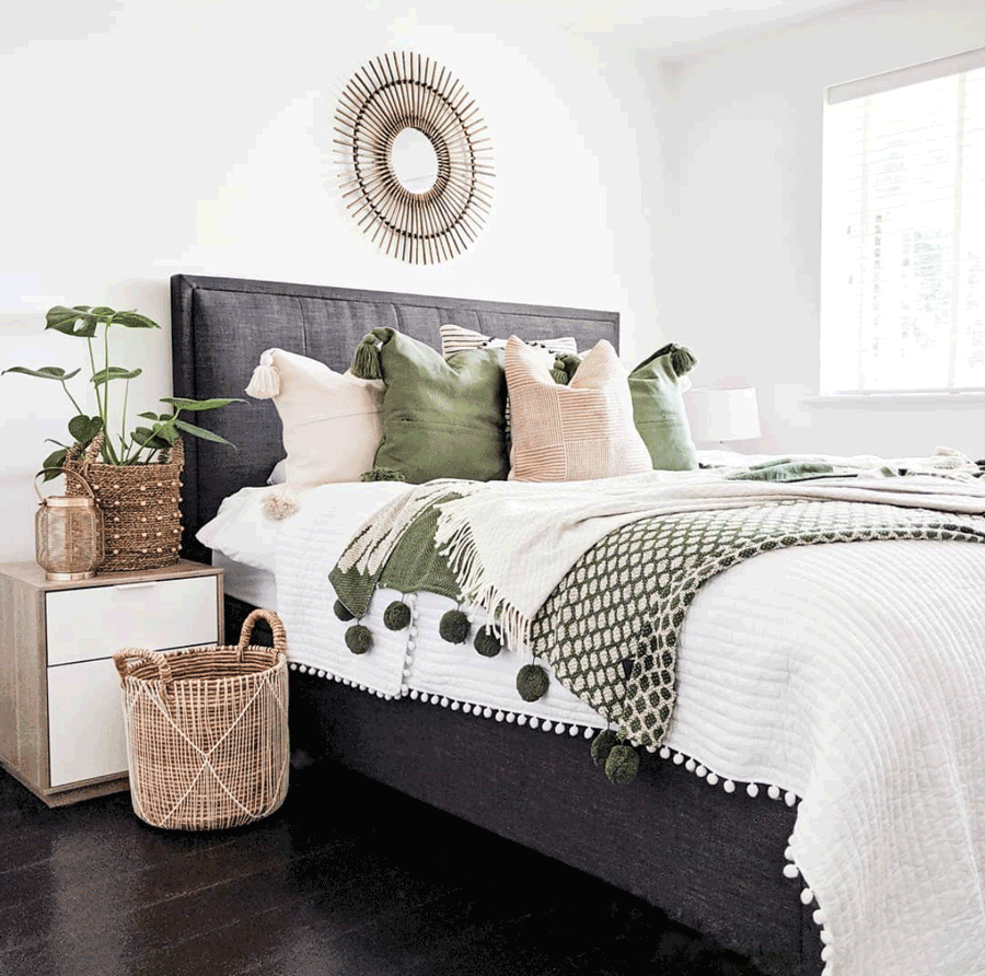 Cozy chic bedroom in Minneapolis, MN with pops of green and a style statement color pallet.