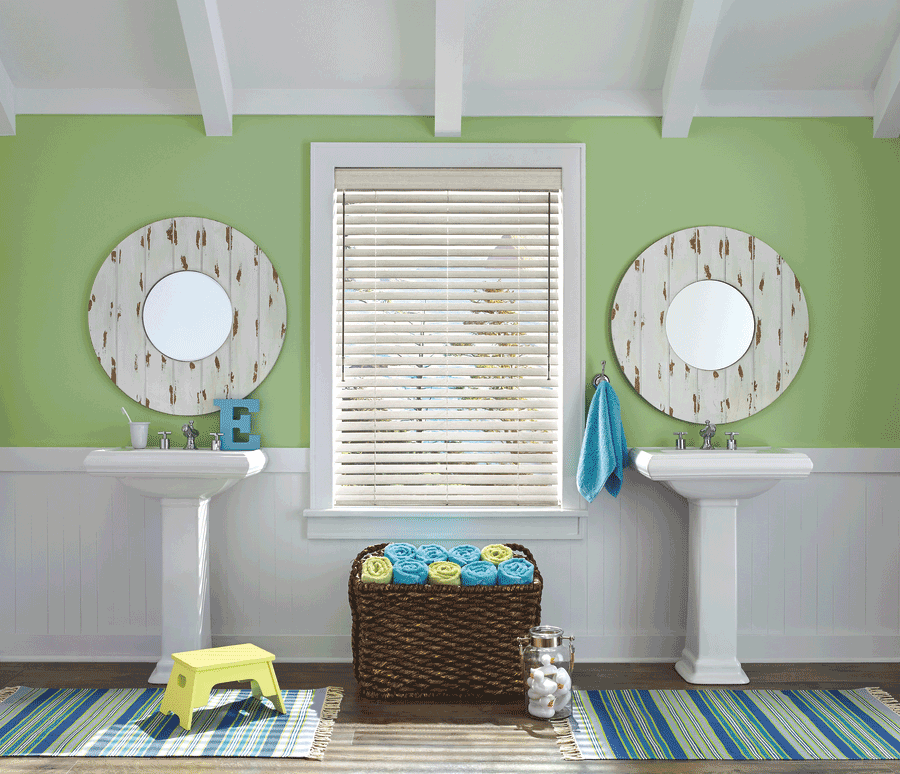 bathroom with two sinks and green wall aero drapery and blind