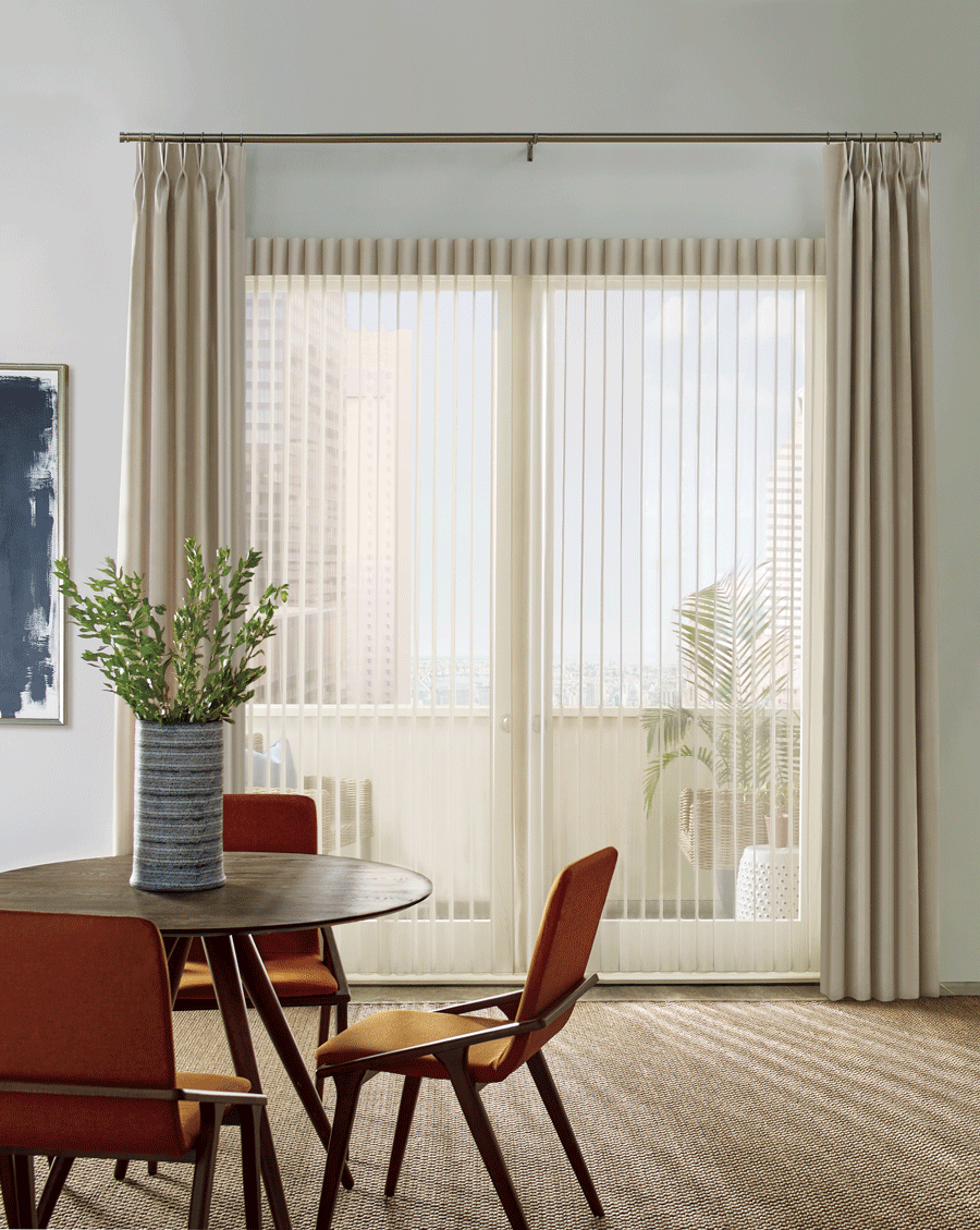 Privacy sheers paired with side drapery panels in dining room.