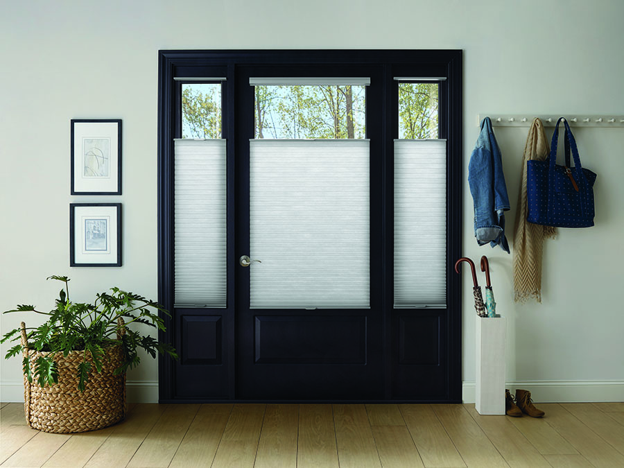 Honeycomb shades adding increased safety on entryway door.