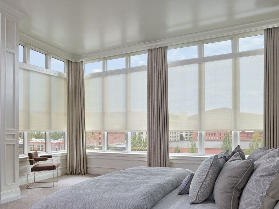 roller shades as floor to ceiling blinds in master bedroom with wall of window covered by solar shades and drapery in Minneapolis, MN