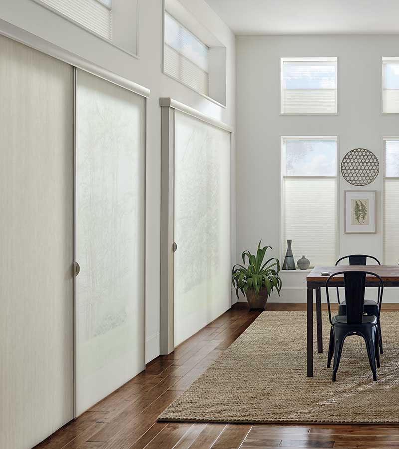 contemporary dining room with sliding glass doors and dual opacity white window shadings in Burnsville 55337