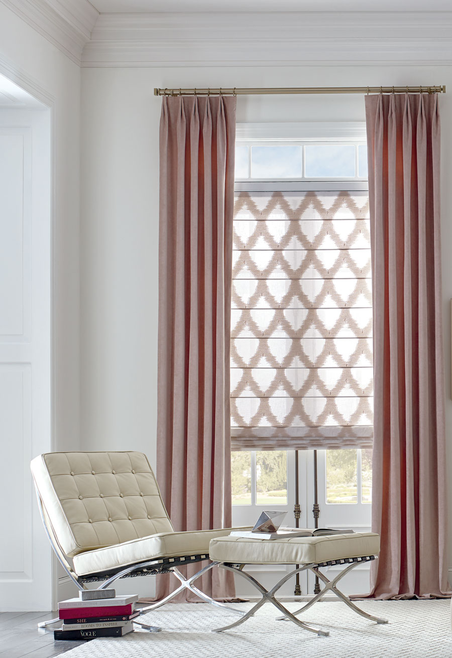 Patterned shades paired with pink draperies.