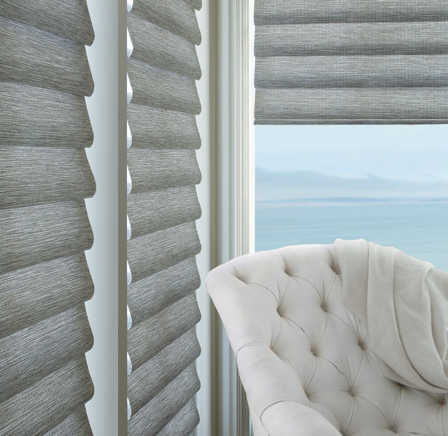 Gray roman shades on floor to ceiling windows