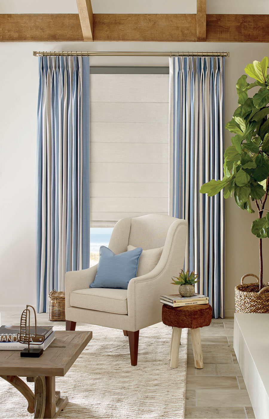 Striped draperies with roman shades in living room