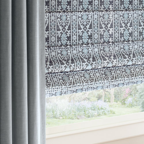 coordinating blue velvet drapery and blue patterned window shades