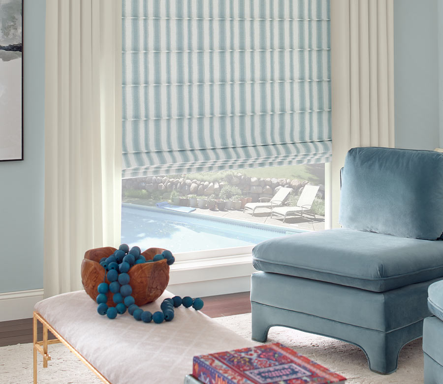 modern living room with plush teal velvet chair and drapes with blue and white stripes Minneapolis, MN