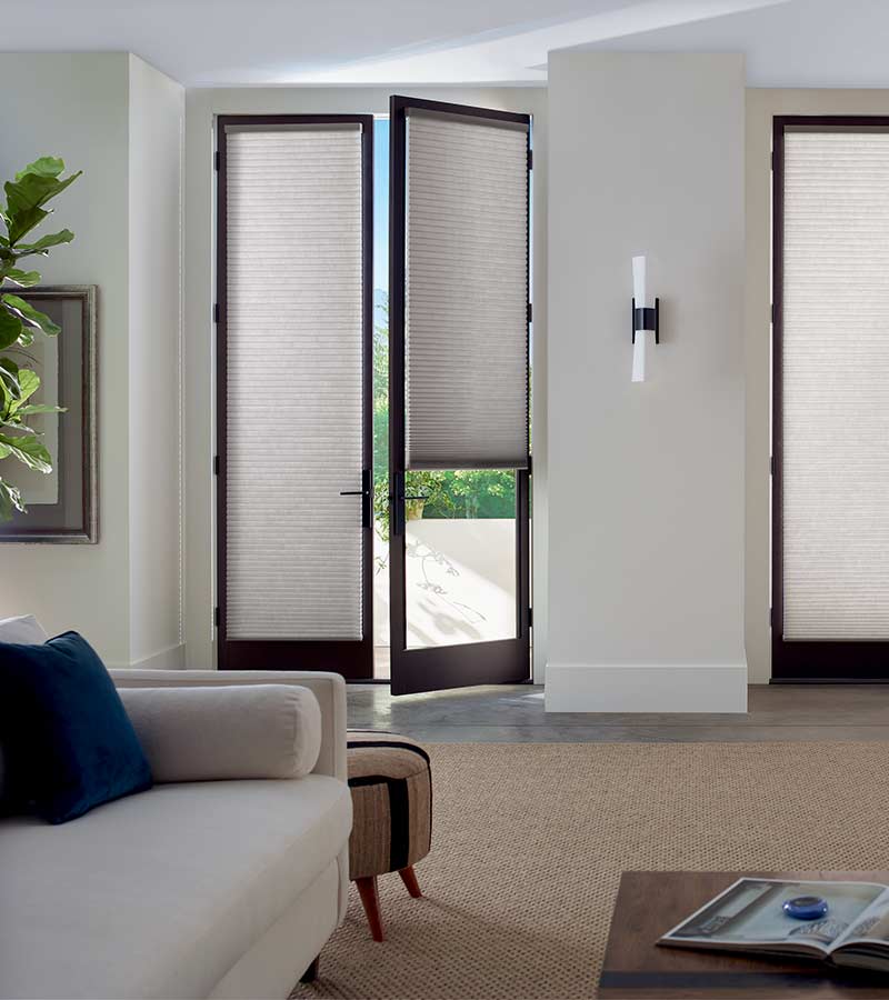 partially open glass door with gray cellular shades in Burnsville, MN
