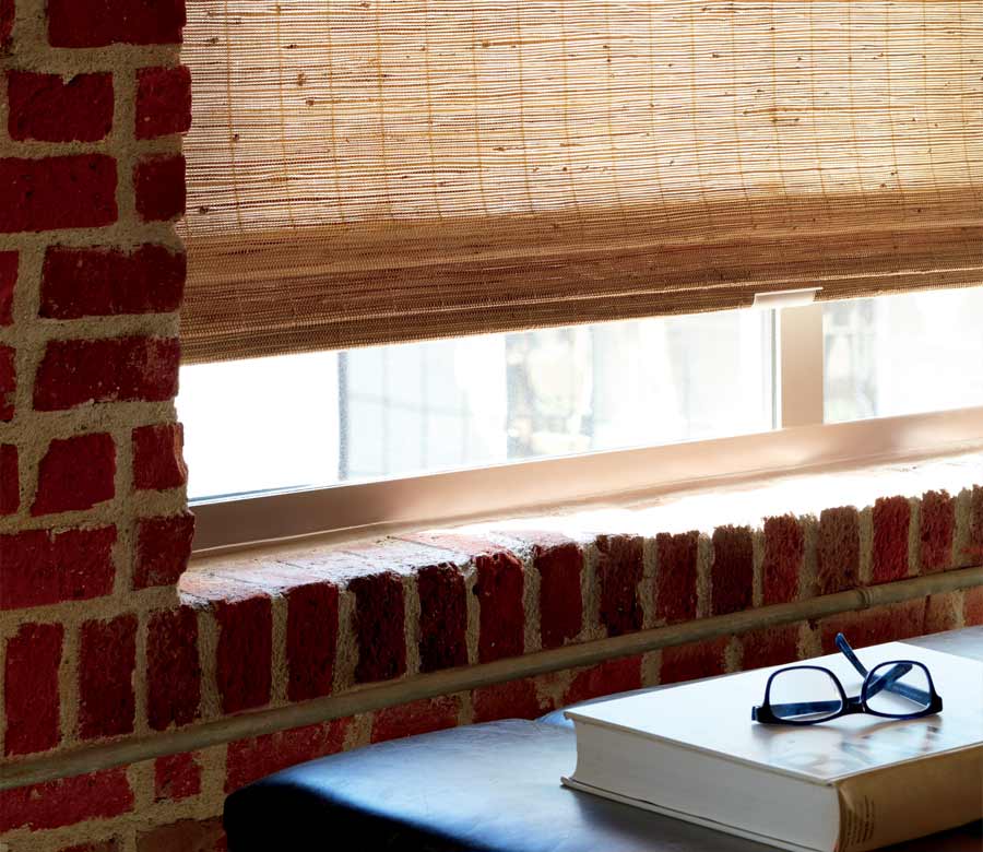 detail of custom woven shades in exposed brick apartment building Minneapolis, MN