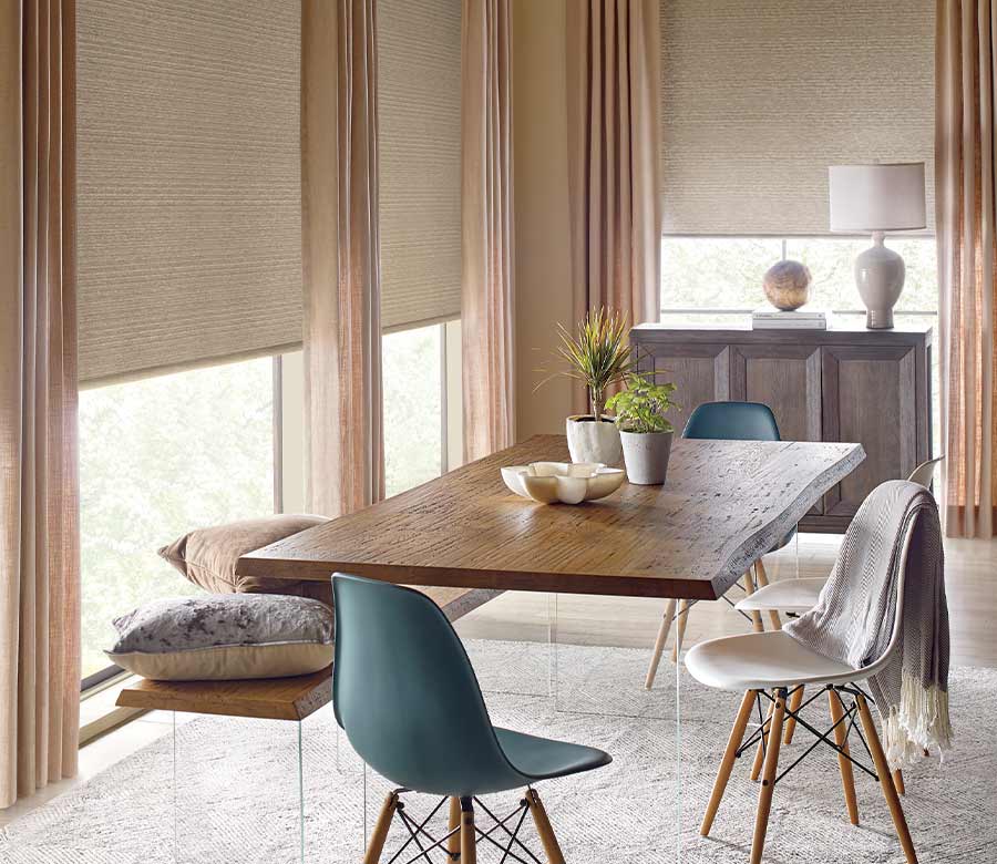 modern dining set close to windows with roller shades and drapery