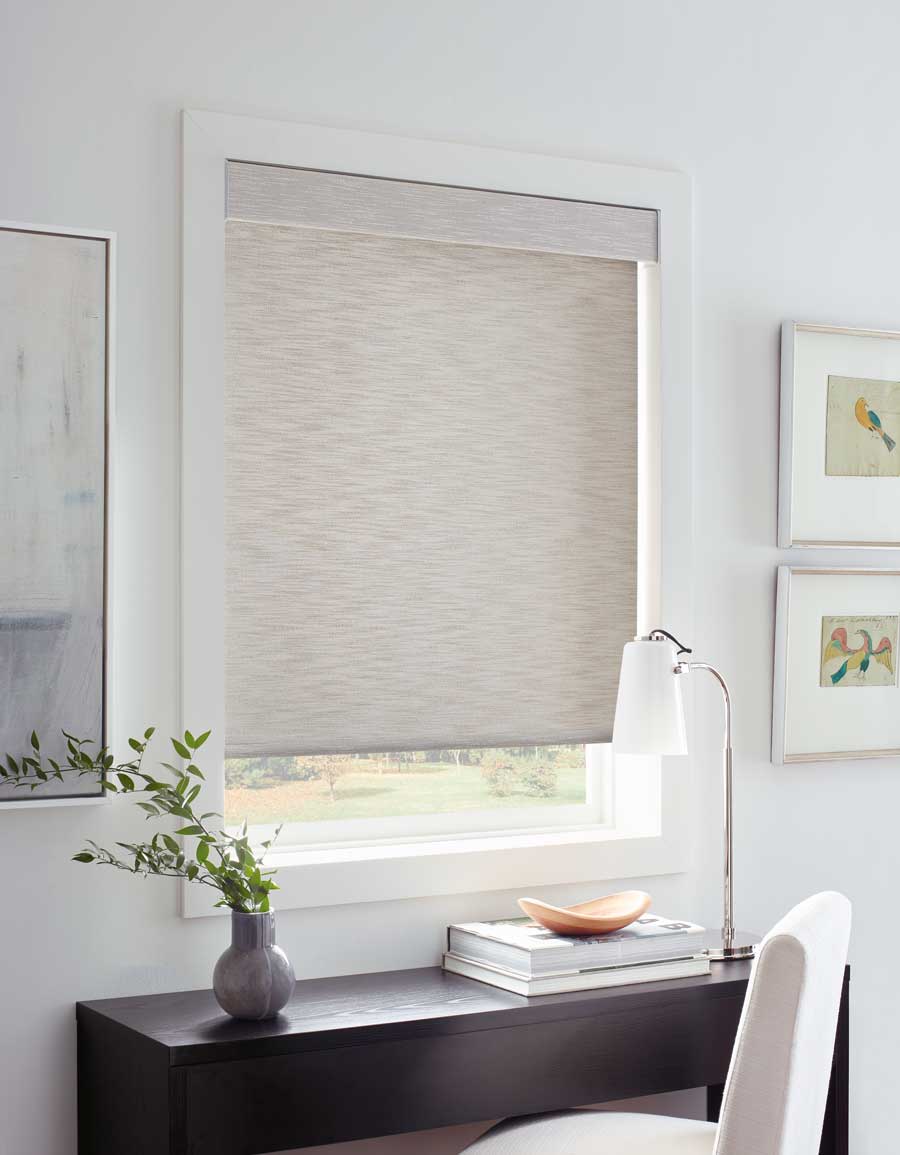 beige roller shades in home office