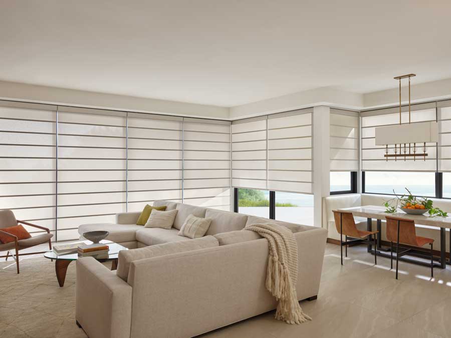 Alustra® Architectural Shades in a living room that has floor to ceiling windows