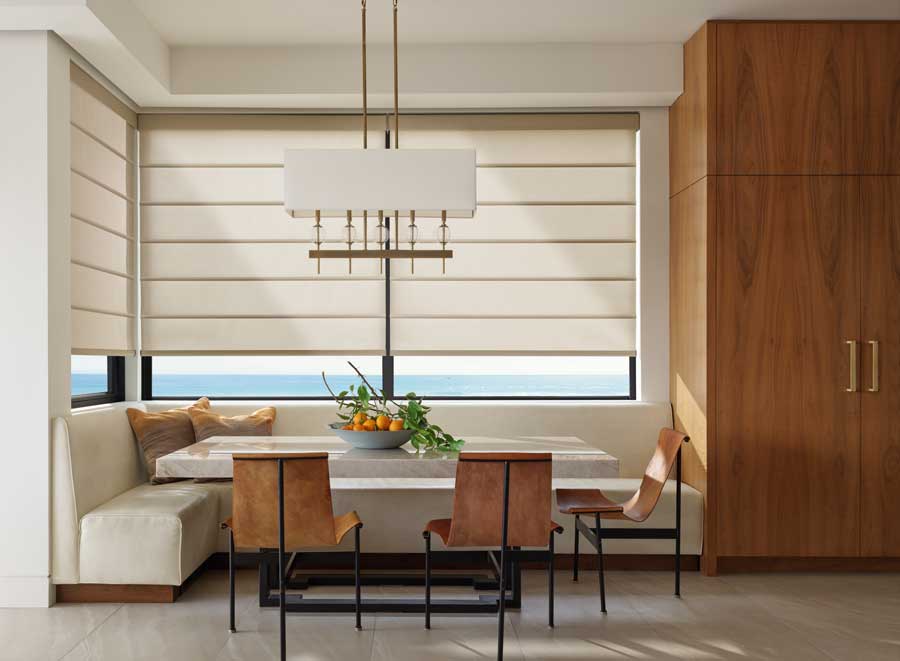 Alustra® Architectural Shades in a corner window over a dining area in a modern home.