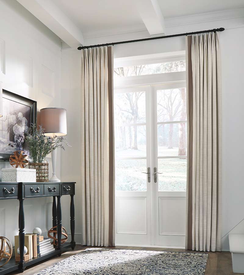 custom window drapery on glass doors in entryway