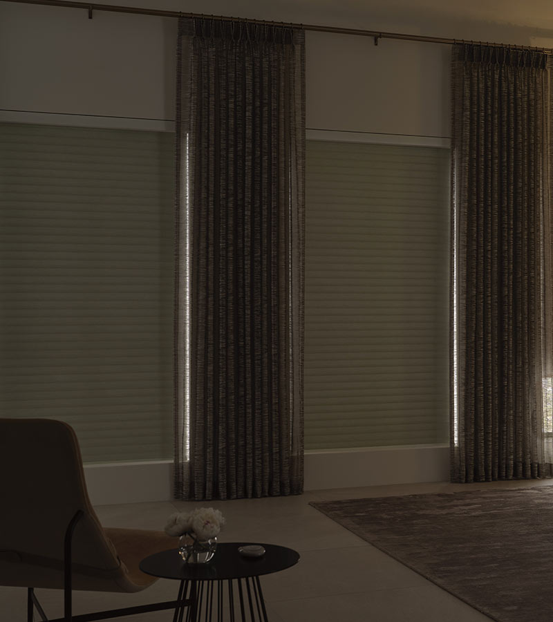 living room with black out window coverings and drapery in living room