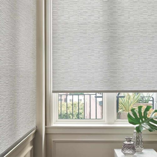designer-roller-shades-corner-window-hunter-douglas-aero-drapery-and-blind designer roller shade in a corner window dining room