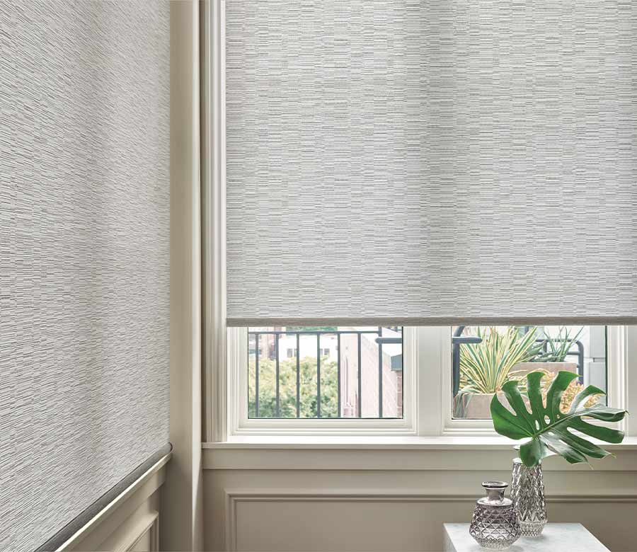 designer roller shade in a corner window dining room