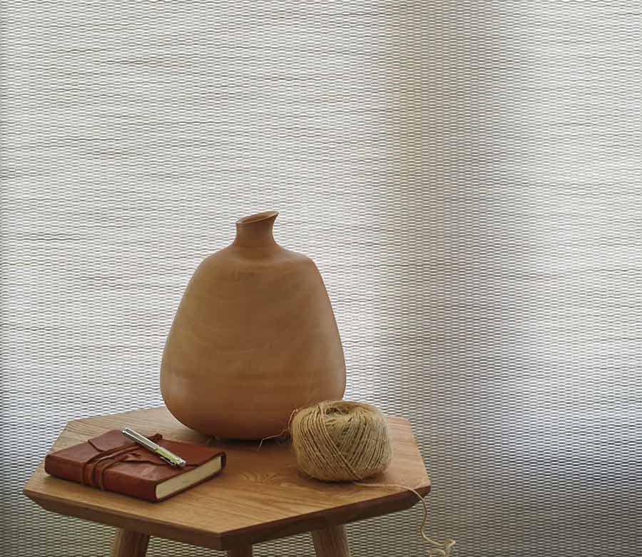 white designer roller shade with decor on a table
