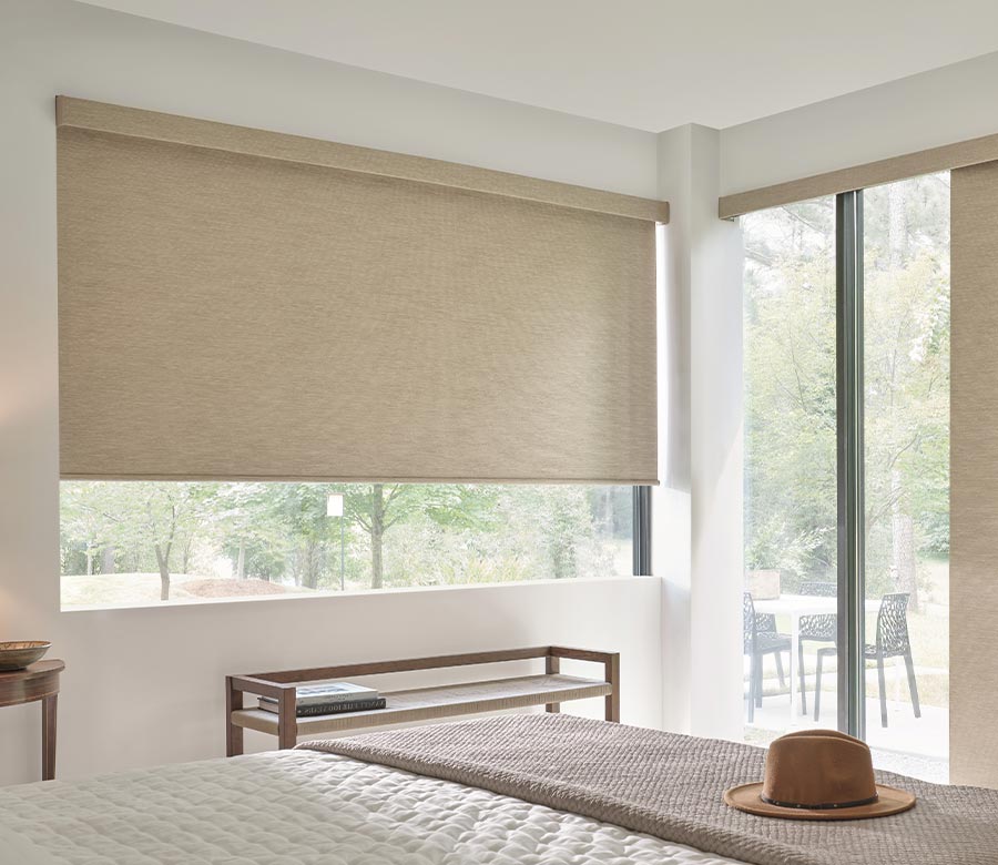 bedroom with creme designer roller shades