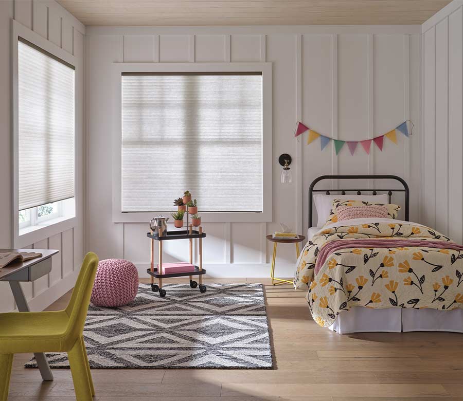 applause-honeycomb-cellular-shades-hunter-douglas-aero-drapery-and-blind children bedroom with white cellular shades honeycomb with colorful bedding