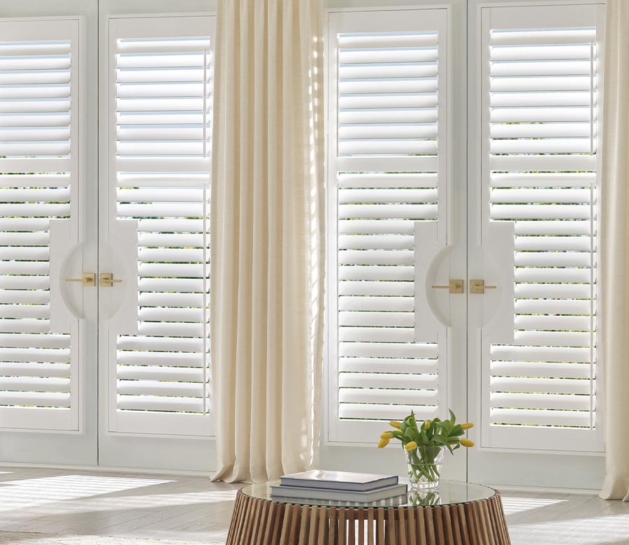 french doors with white palm beach vinyl shutters and neutral drapery