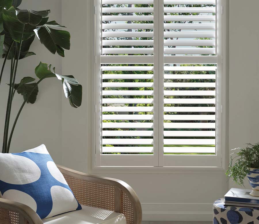 white vinyl shutters with standard hinge at window in living room