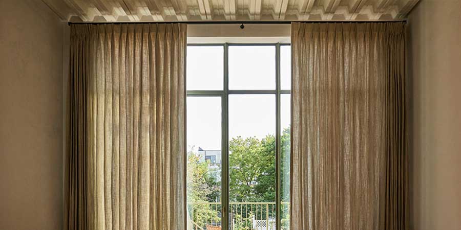 pinch pleat drapery on either side of windows