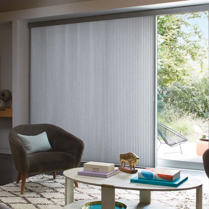 vertical honeycomb shades on large patio doors in living room