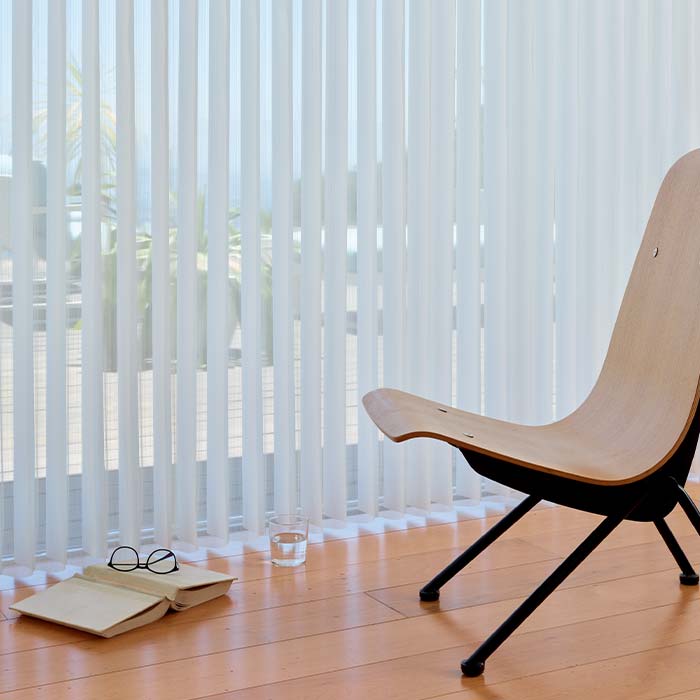vertical sheer shades covering sliding glass doors in modern dining room
